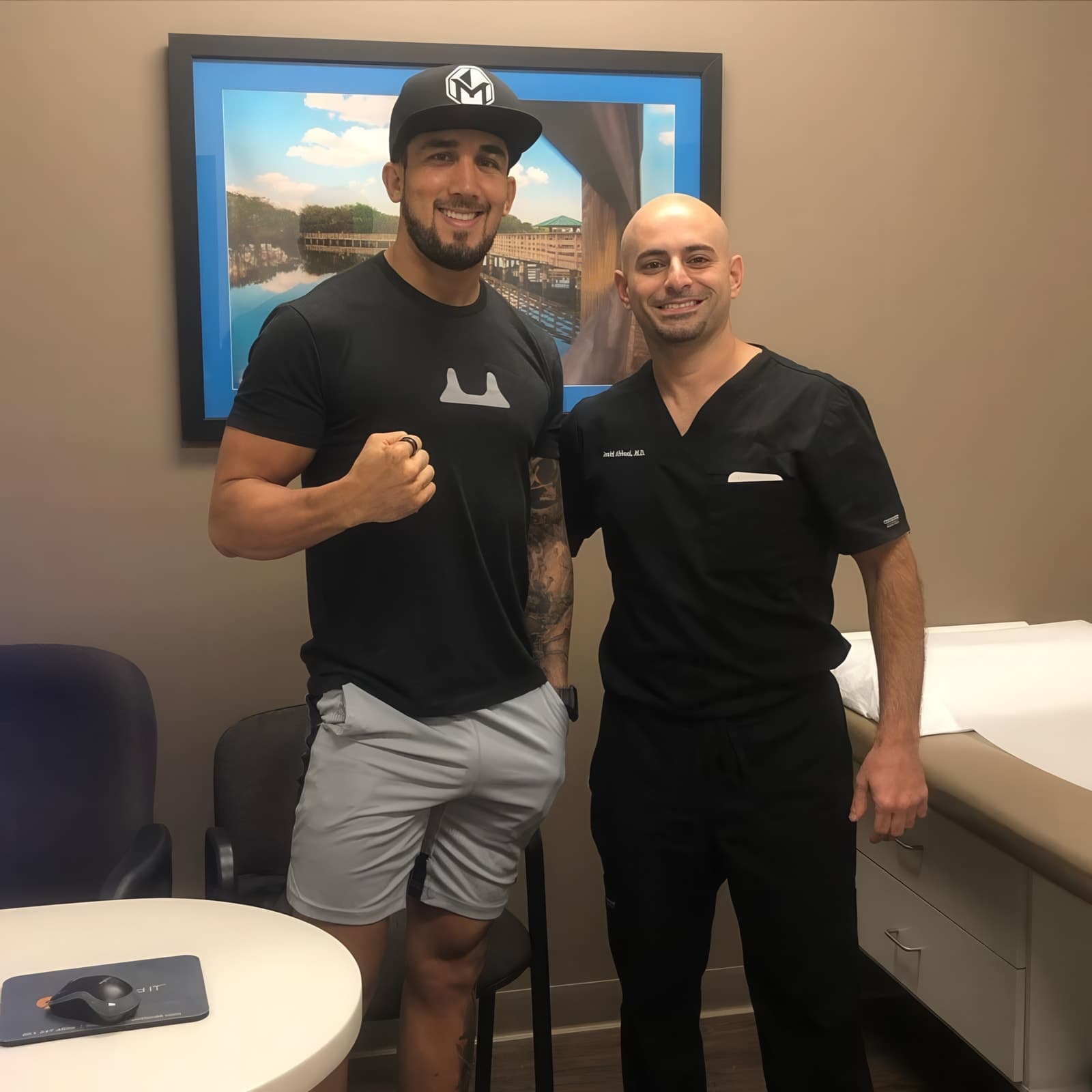 Dr. Abbasi with an athlete in the examination room