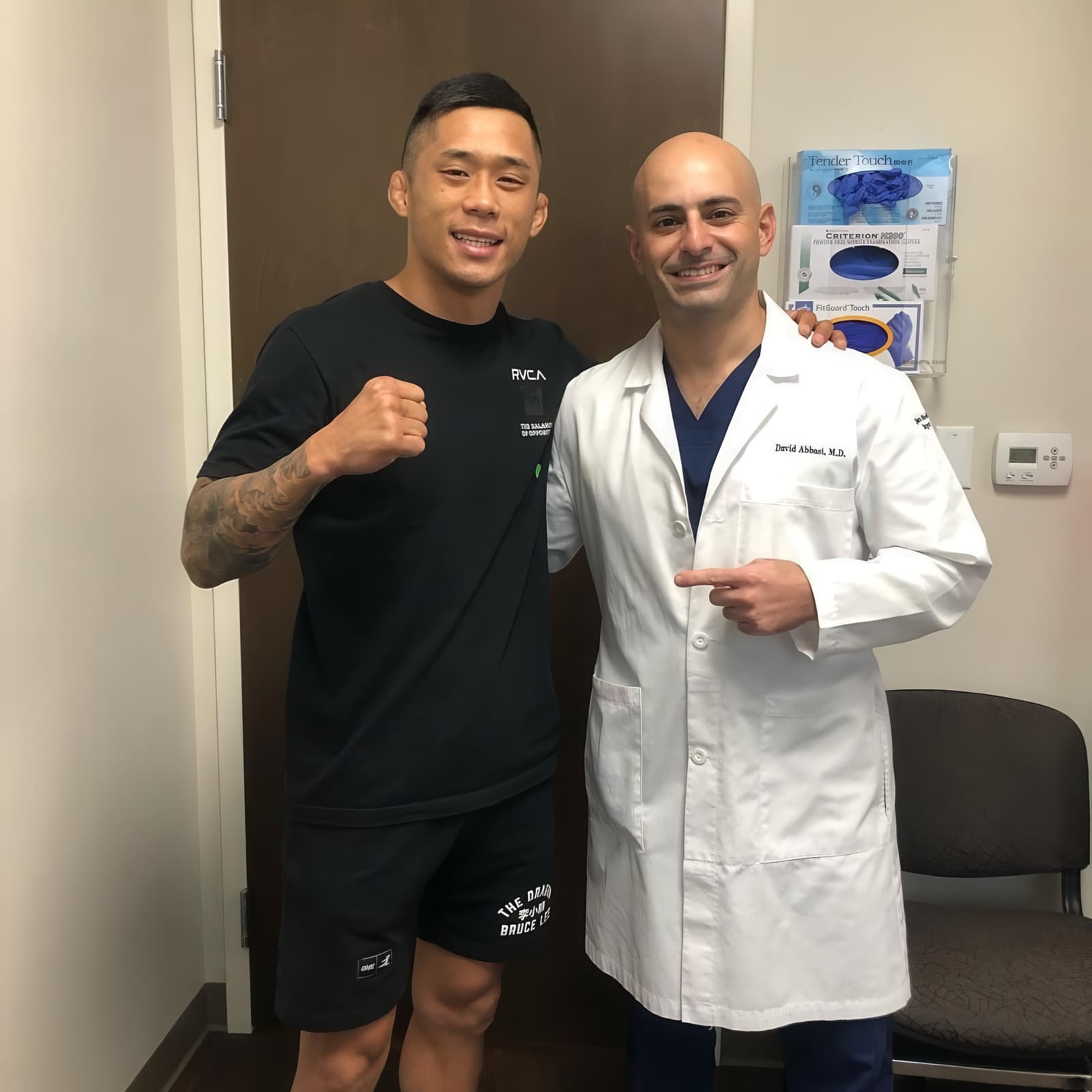Dr. Abbasi with an athlete in ONE Championship kit